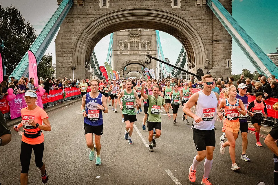 Runners cross Tower Bridge during the 2021 London Marathon.