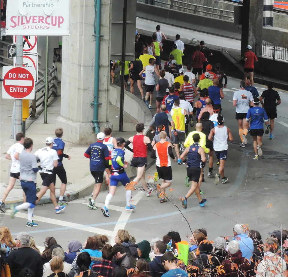 Runners round onto the Queensboro Bridge from Queens during the 2013 New York City Marathon.