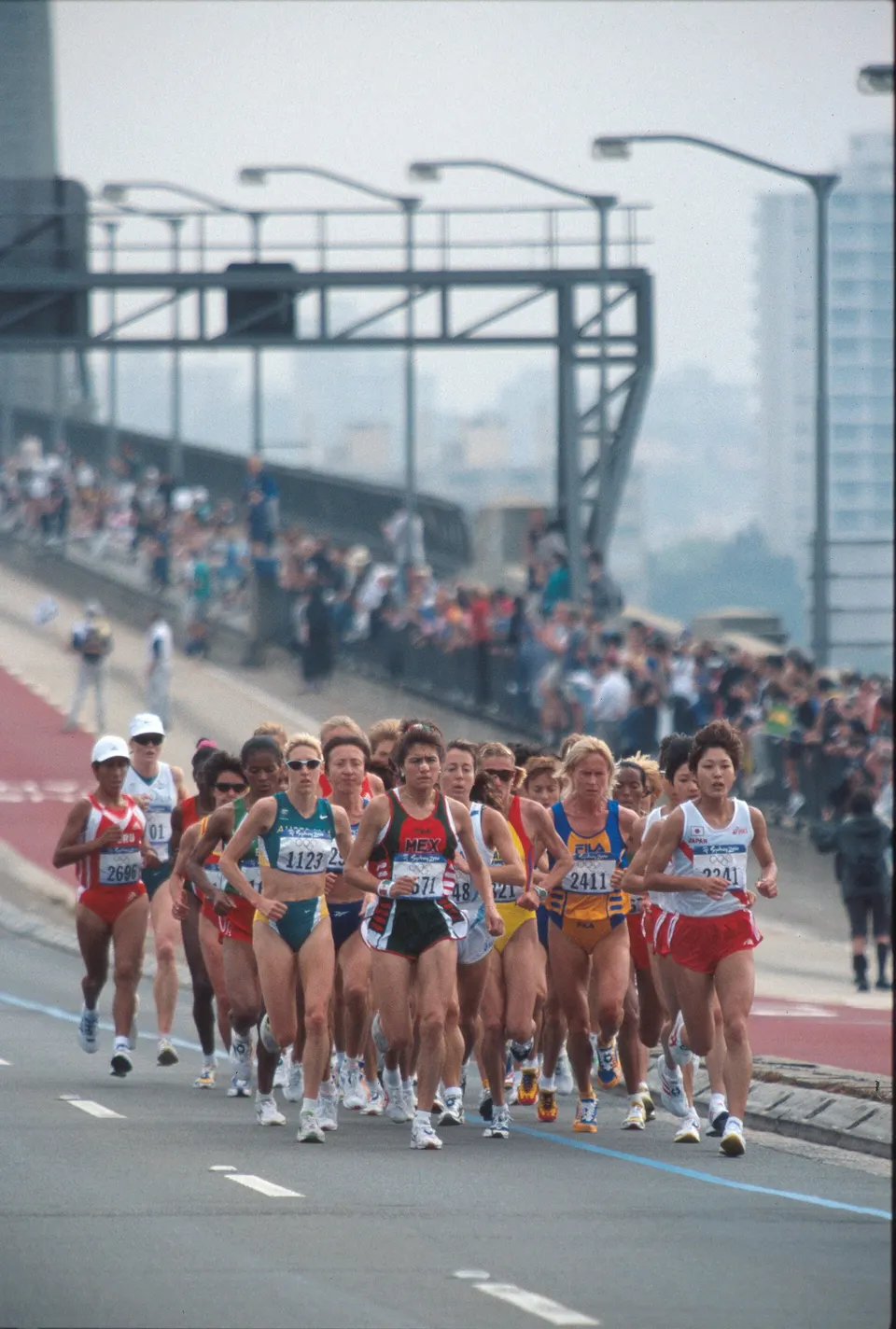 The women’s marathon field crosses the Sydney Harbour Bridge at the 2000 Olympic Games.