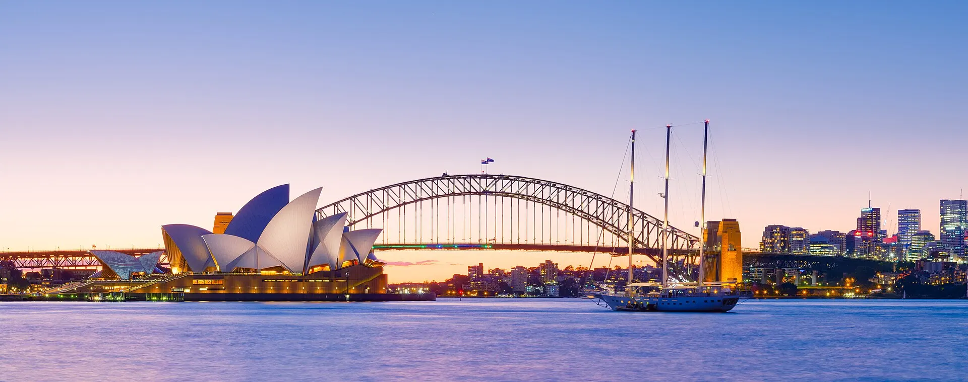 The Sydney Opera House and Harbour Bridge at dusk.